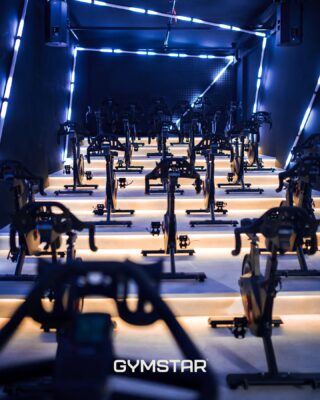 a room with exercise bikes and lights