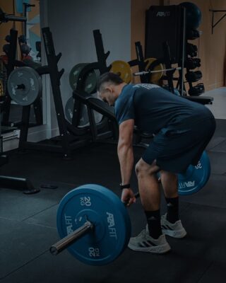a man lifting weights in a gym